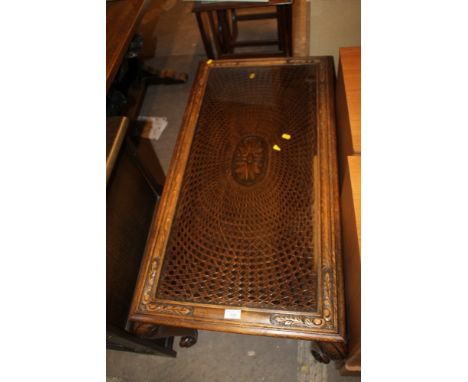 A CARVED OAK GLASS TOP COFFEE TABLE 