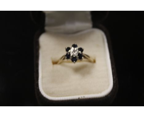 A 9CT GOLD DIAMOND AND SAPPHIRE LADIES DRESS RING