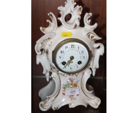 A CERAMIC MANTLE CLOCK WITH FRENCH MOVEMENT
