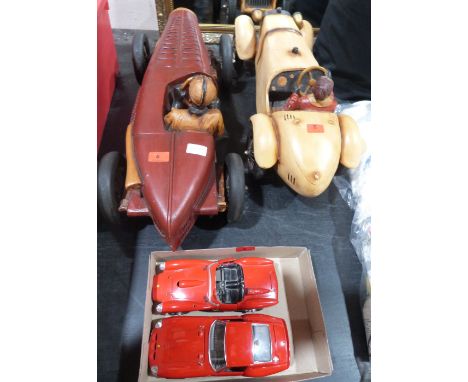 Two diecast Ferrari models and two resinous model cars