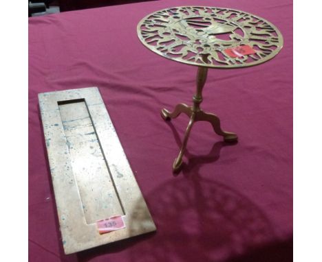 A brass letterbox aperture and surround together with a miniature brass tripod table