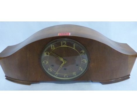 An Art Deco walnut mantle clock, the three train movement striking and chiming on five tubular gongs. 23' wide