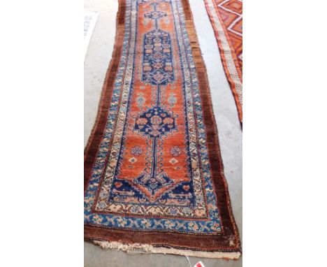 A tan and blue ground Eastern carpet runner. 120' x 36'