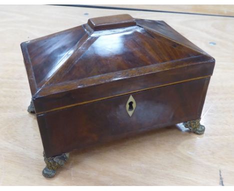 GEORGE III MAHOGANY TEA CADDY, sarcophagus shaped on three bacchanalian embossed brass tab feet, 8 1/4" (20.9cm)  wide (lacks