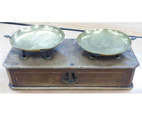 SHOP BALANCE SCALE with two loose brass circular pans operating on an inlaid mahogany oblong box base, 19" wide 