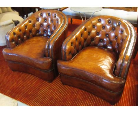 CLUB ARMCHAIRS, a pair, faded vintage tan brown leather upholstered each with deep rounded button back and stud detail, 82cm 