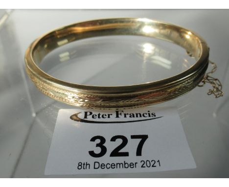 9ct gold hinged and engraved bangle. Approx weight 11.8 grams.(B.P. 21% + VAT) 
