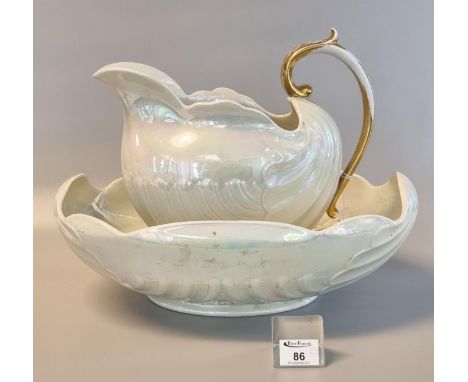 Shelly lustre china shell-shaped jug and basin, jug with gilded handle. (2)(B.P. 21 + VAT) Some wear to gilding. Chip to base