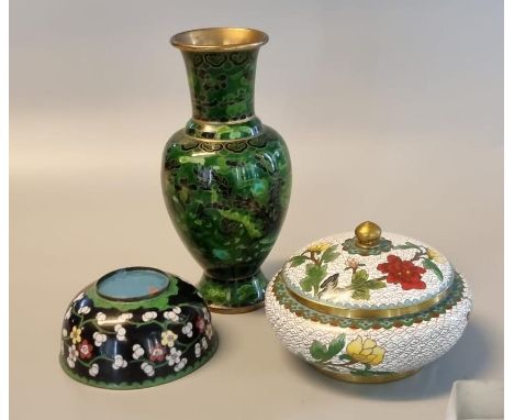 Three items of Oriental cloisonne ware to include green ground baluster shaped vase, black ground open bowl, and a white grou