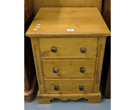 Natural pine bedside chest or lamp table with three cock beaded drawers having turned knobs. 46cm wide approx.(B.P. 21% + VAT