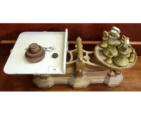 Set of grocer's scales with ceramic platform and an assortment of weights including a graduated set of bell-shaped weights.(B