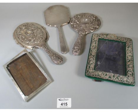 Collection of silver repousse and engine turned hand mirrors, one decorated with exotic birds, dogs and landscape, together w