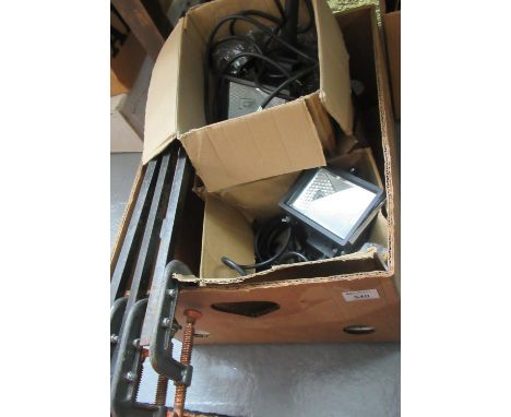 Box of assorted items to include: three rectangular work lights lights and vintage clamps on long metal poles. (B.P. 21% + VA