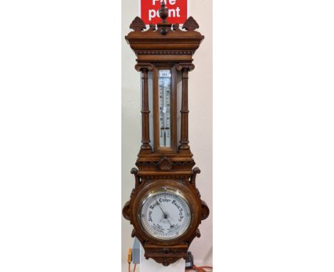 Late Victorian oak wheel barometer of architectural form with thermometer, the face marked 'J Davies Ltd, Swansea'. Overall 1