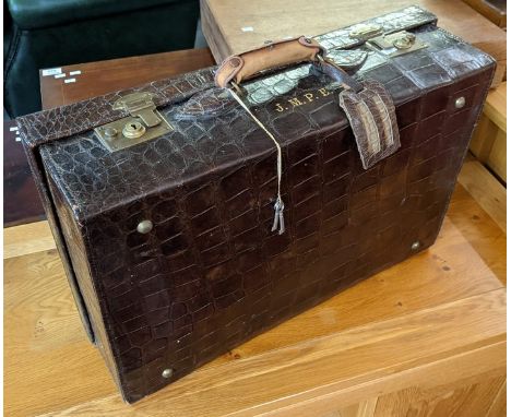 Early 20th Century crocodile skin suitcase with fitted interior including lift out shelf and having original canvas cover. (B