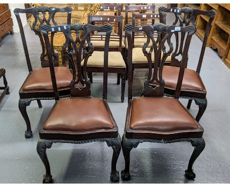 A set of four Chippendale style mahogany dining chairs with drop in seats standing on carved cabriole legs and ball and claw 