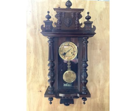 A Vienna wall clock with pendulum. W:40cm x D:16cm x H:85cm