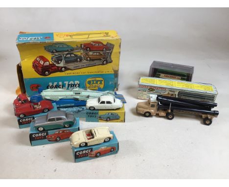 A Corgi Carrymore car transporter with four boxed cars. In played condition. Also with a Dinky Tracteur unic Saharien in play