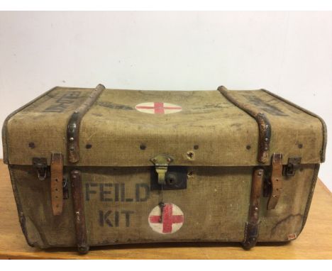 A large military canvas and wooden bound trunk with leather straps . Stencilled with Feild kit W:80cm x D:53cm x H:40cm
