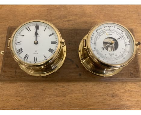 A combination barometer thermometer also with a ship spell clock both by Schatz in brass with bevelled glass faces mounted on