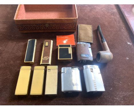 A collection of vintage lighters and a pipe to include: S.J.Dupont Paris lighter ,two gold plated Dunhill lighters, one marke
