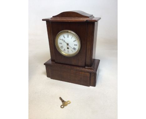 A wooden mantle clock with keyW:30cm x D:15cm x H:38cm also with a round glass topped table 