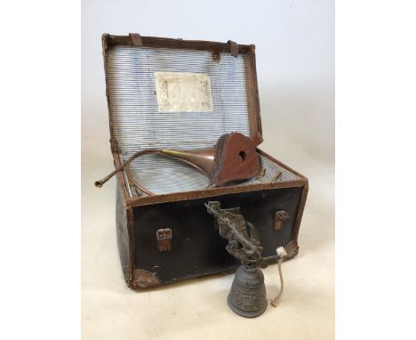 A vintage leather bound trunk with a brass hunting horn, bellows and a metal door bell