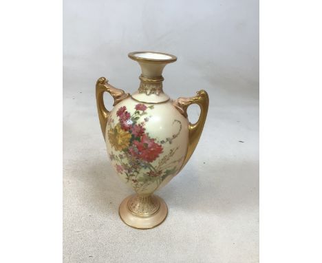 A Royal Worcester hand painted twin handled vase hand decorated to front and back with floral sprays. Worn factory mark to ba