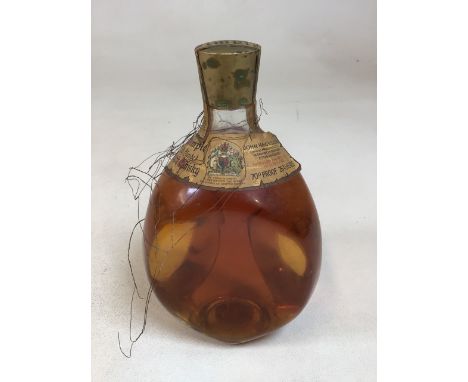 A bottle of Dimple Old Blend Scotch Whisky circa 1966