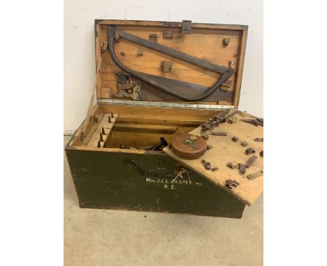 A vintage box with a collection of tools. Marked with military MJR.J.E.L Carter.  