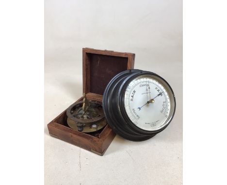 A boxed brass sundial compass and a Negretti and Zambra metal surround circular barometer 