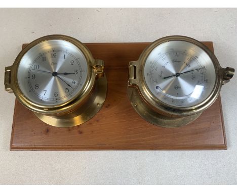 A Barigo brass barometer - thermometer and brass clock mounted on wooden plaqueW:36cm x D:20cm 