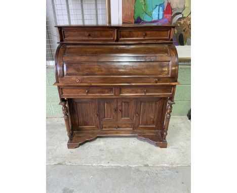 A good quality continental import hardwood roll top desk with many drawers and hidden compartments with removable secretaire 