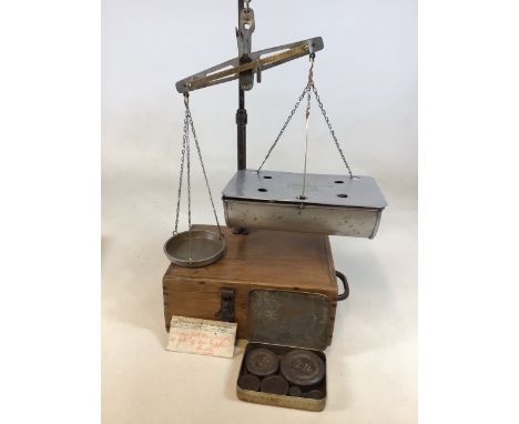 A boxed set of scales with tin of weights. By A H Griffin and Co Coventry