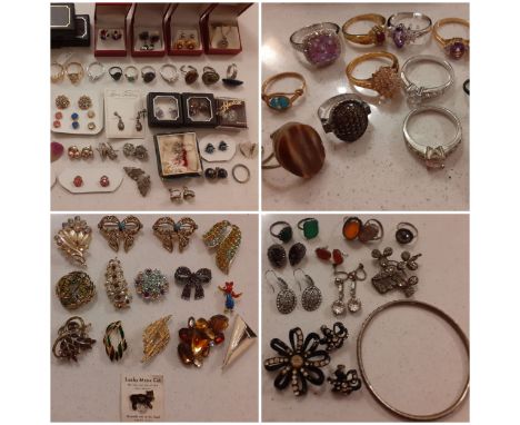 An early 20th Century engraved silver ring, semi precious stone and white metal rings and earrings to include amber and green