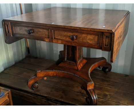 A Regency mahogany sofa table having four drawers, square tapering column, quatrefoil base with scroll feet, 74h x 93wquatref