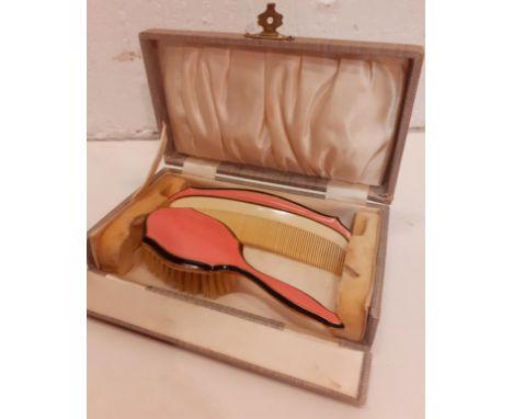 A vintage child's enamel brush and comb set in pink and cream together with a fitted box. Location:If there is no condition r