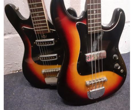 A Hondo 4-string electric sunburst bass guitar together with an un-named 6-string electric sunburst bass guitar. Location:RWF