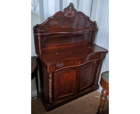 A Victorian mahogany chiffonier having a serpentine front, barley twist columns and two cupboard doors, 148cm h x 105cm wLoca