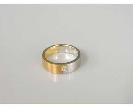 An 18ct yellow and white gold satin finish flat section band ring, set with a princess cut diamond