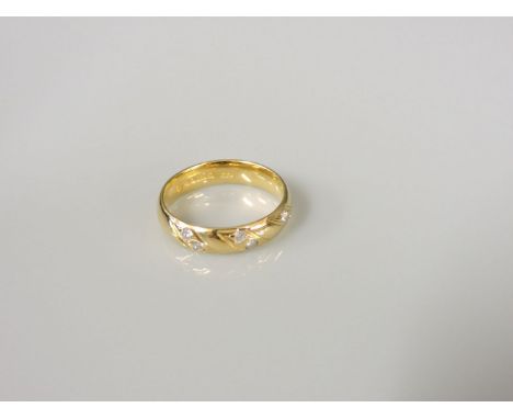 An 18ct gold diamond set wedding ring