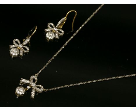 An Edwardian style diamond set pendant and earring suite, with diamond set bow with a diamond set cluster articulated below, 