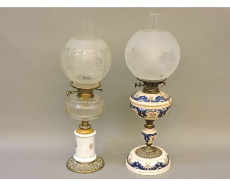 A Victorian oil lamp, with painted glass column with portrait detail, a Wright & Butler double burner, 60cm, and a further oi