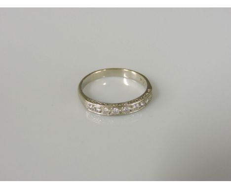 A white gold diamond set half eternity ring, marked 18ct