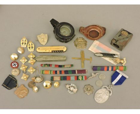 Various military items, including a compass and pen knives