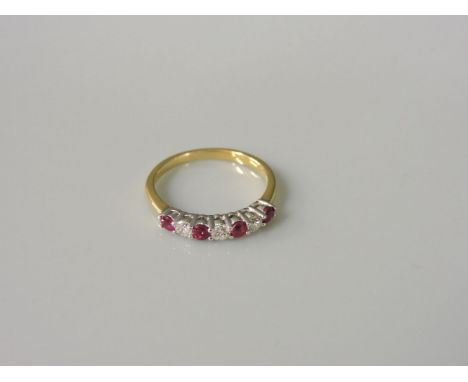 An 18ct gold ruby and diamond half hoop ring