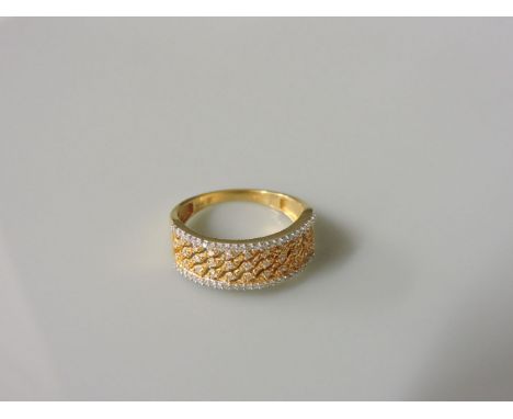 An 18ct yellow and white gold diamond set band ring, with pierced diagonal waves