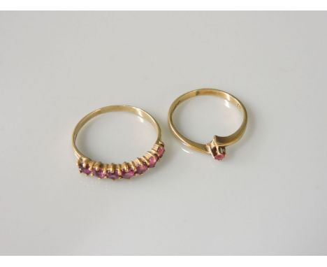 A 9ct gold ruby half eternity ring, and a 9ct gold single stone ruby crossover ring