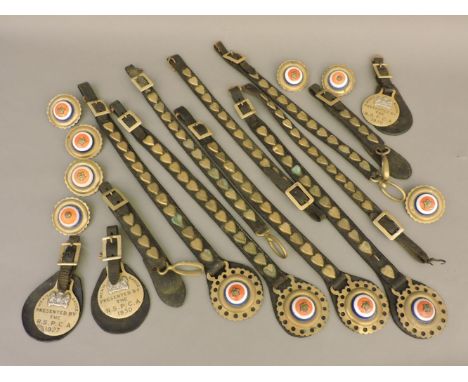 Nine leather horse harness straps, with brass hearts, three RSPCA Parade Merit brass badges, 1927 and two for 1930, and seven