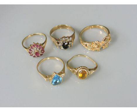 A 9ct gold sapphire and diamond cluster ring, a ruby and diamond pear shaped cluster ring, a yellow paste ring marked 10kt, a